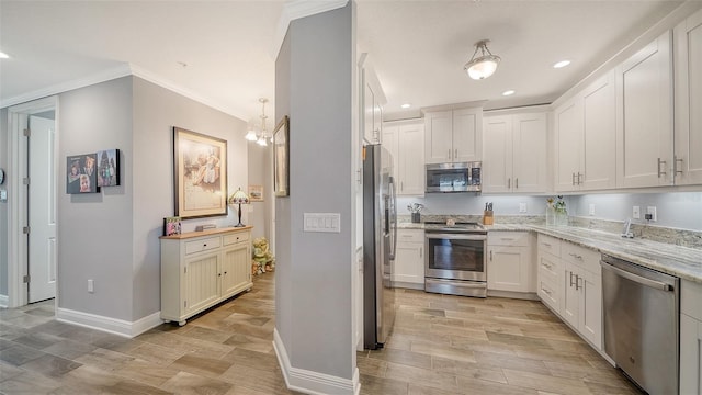 kitchen featuring light stone countertops, light wood-style flooring, recessed lighting, white cabinets, and appliances with stainless steel finishes