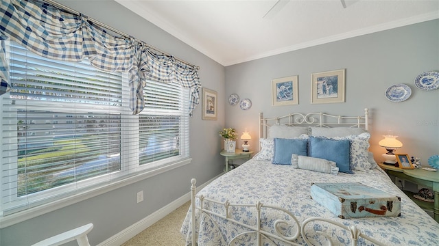 bedroom with crown molding, carpet flooring, and baseboards