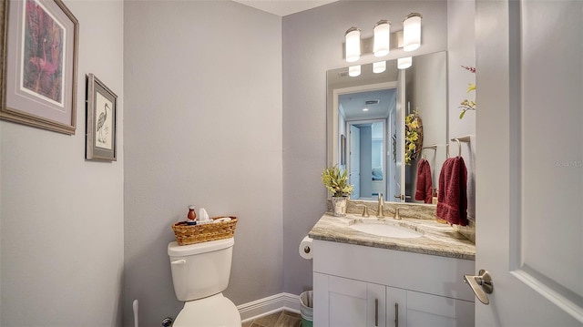 bathroom featuring vanity and toilet