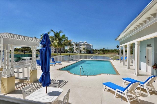 community pool featuring a patio, fence, and a pergola