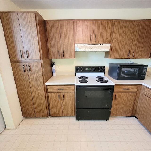 kitchen featuring under cabinet range hood, black microwave, light countertops, and electric range oven