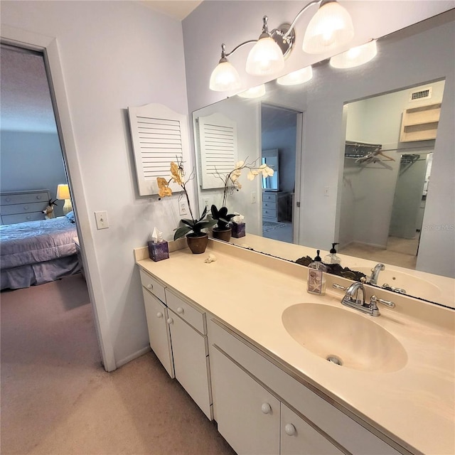 bathroom with vanity, ensuite bath, baseboards, and visible vents