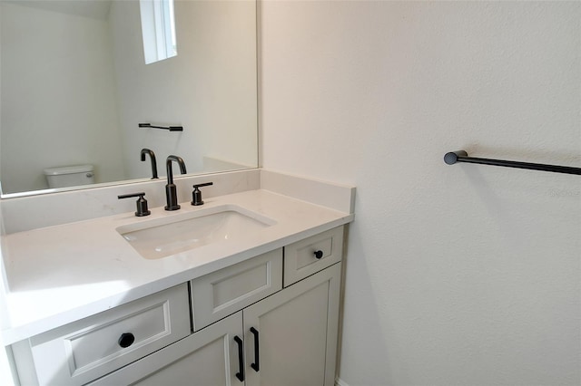 bathroom with toilet and vanity