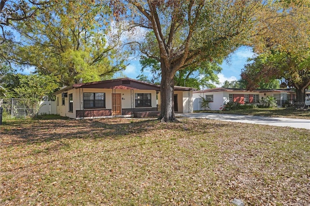 124 E 119th Ave, Tampa, FL 33612 - ranch-style home with driveway, a front yard, an attached garage, and fence