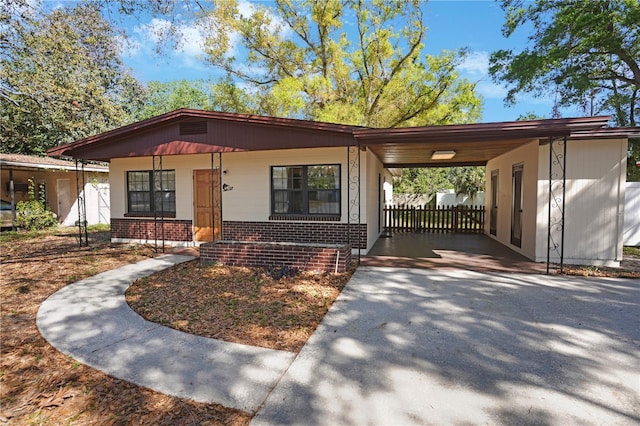 124 E 119th Ave, Tampa, FL 33612 - view of front of home with driveway, a carport, a porch, and brick siding