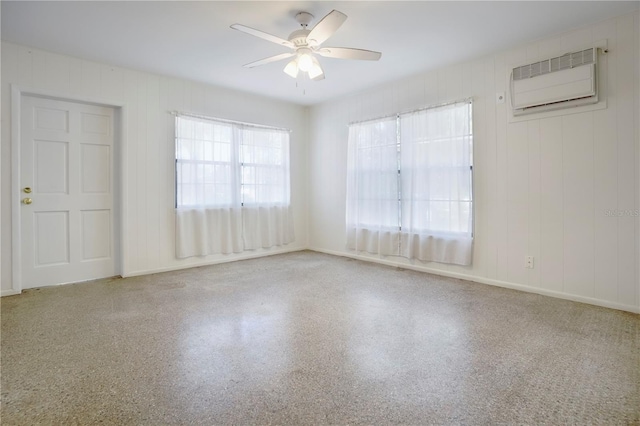 124 E 119th Ave, Tampa, FL 33612 - spare room featuring speckled floor, a wall mounted air conditioner, and ceiling fan