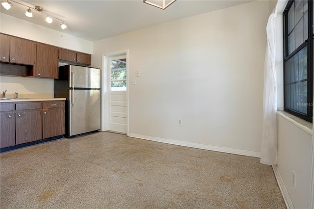 124 E 119th Ave, Tampa, FL 33612 - kitchen with baseboards, light speckled floor, a sink, and freestanding refrigerator