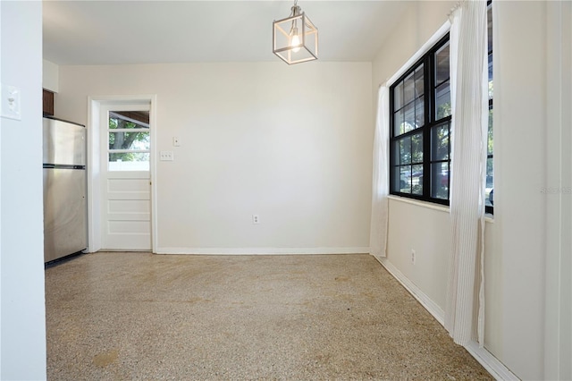 124 E 119th Ave, Tampa, FL 33612 - unfurnished dining area with baseboards and speckled floor