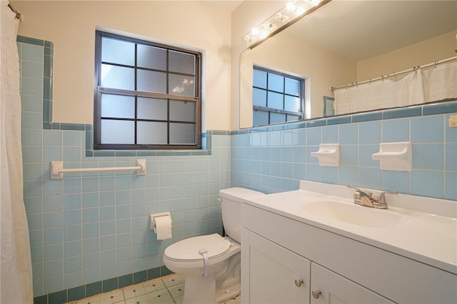 124 E 119th Ave, Tampa, FL 33612 - full bathroom featuring toilet, vanity, tile patterned floors, and tile walls