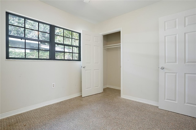 124 E 119th Ave, Tampa, FL 33612 - unfurnished bedroom featuring baseboards and a closet