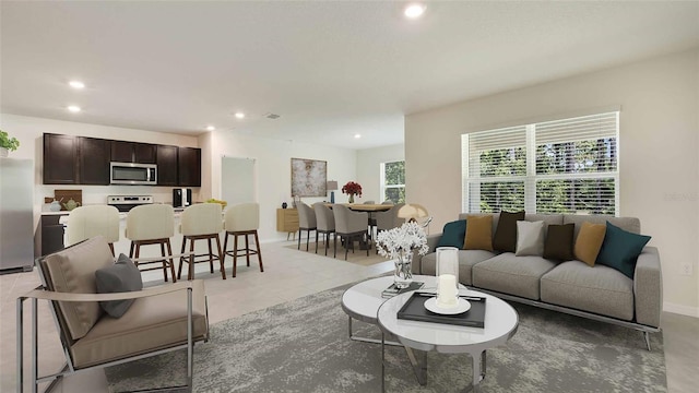 living area with light tile patterned floors, visible vents, recessed lighting, and baseboards