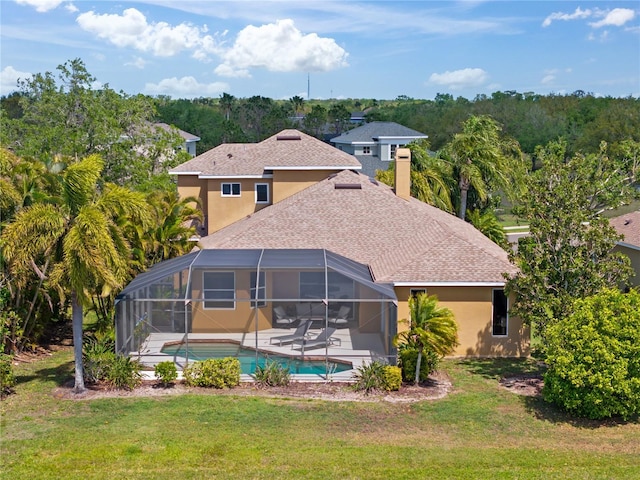 back of property featuring a lanai, a patio area, stucco siding, and a lawn