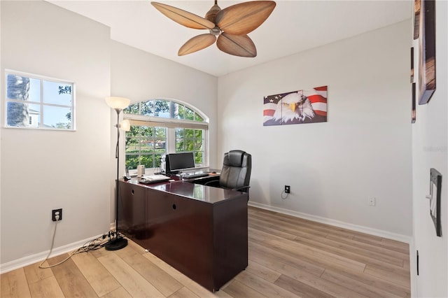 office with a ceiling fan, baseboards, and light wood finished floors