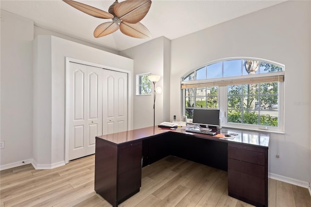 home office with baseboards, light wood finished floors, and ceiling fan