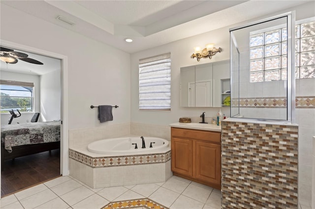 full bath with visible vents, ensuite bathroom, tile patterned flooring, a bath, and vanity