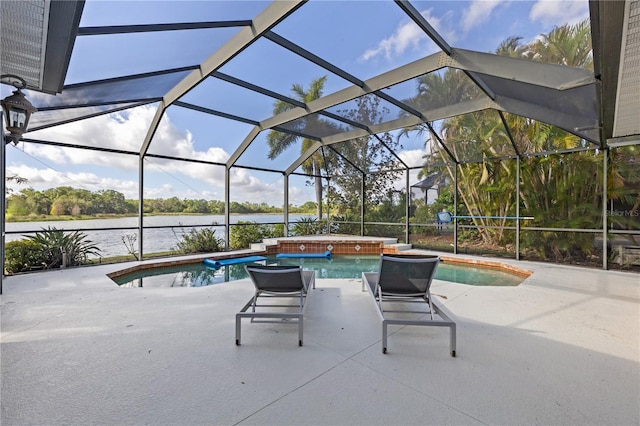 outdoor pool featuring glass enclosure, a water view, a hot tub, and a patio area