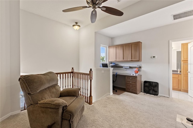 living area featuring visible vents, baseboards, light colored carpet, and a ceiling fan