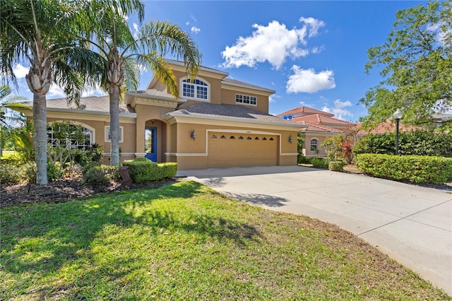 mediterranean / spanish house with stucco siding, a front lawn, an attached garage, and driveway