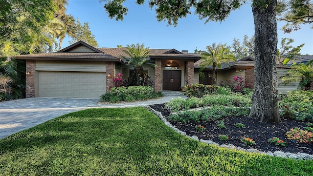 ranch-style home with a front lawn, decorative driveway, brick siding, and an attached garage