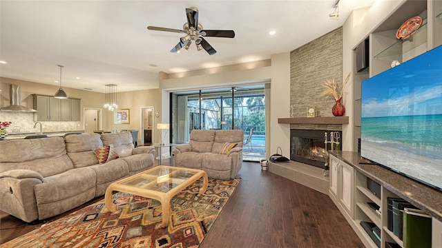 living room featuring a fireplace, dark wood-style floors, recessed lighting, and a ceiling fan