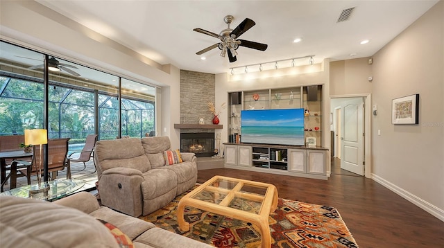 living area with visible vents, baseboards, ceiling fan, and dark wood finished floors