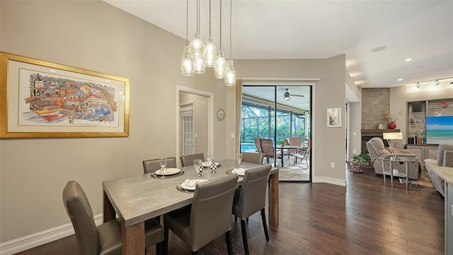 dining area featuring ceiling fan, baseboards, and dark wood-style flooring