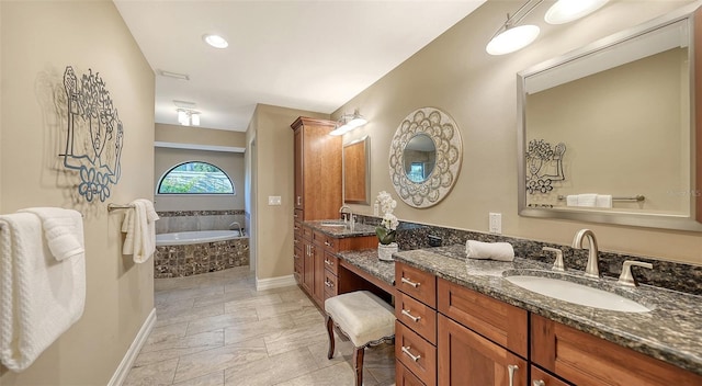 full bathroom with baseboards, a bath, and vanity