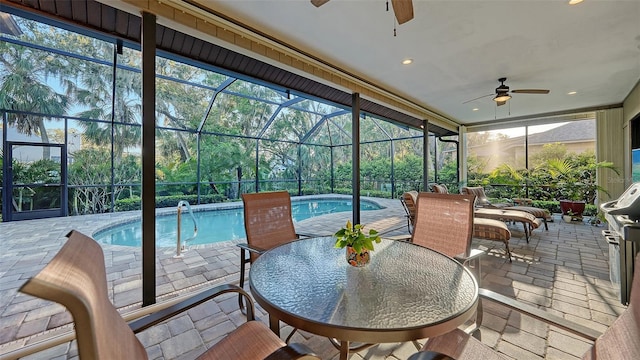 sunroom with a swimming pool and ceiling fan