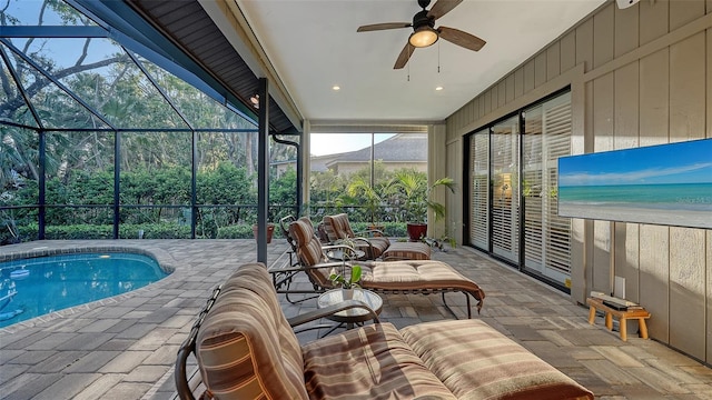 pool with ceiling fan, a patio, and a lanai