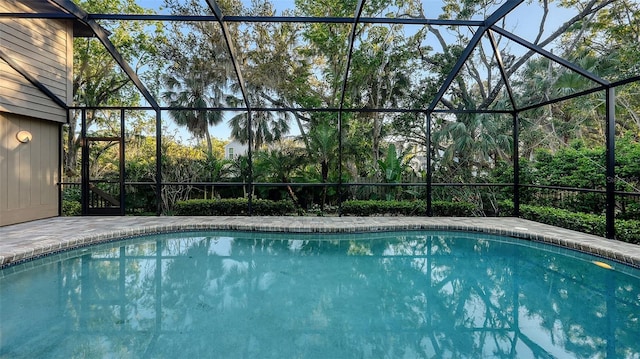 outdoor pool featuring glass enclosure