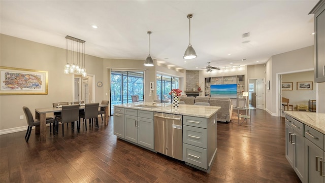 kitchen featuring a ceiling fan, dark wood finished floors, a sink, gray cabinetry, and dishwasher