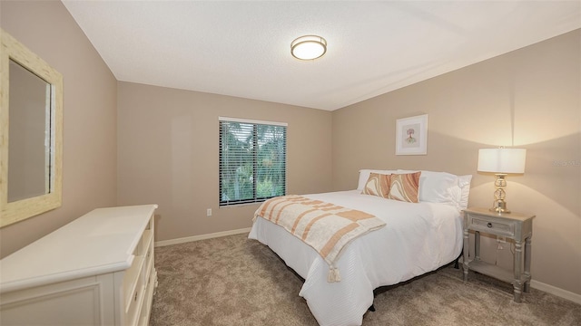 bedroom featuring light carpet and baseboards