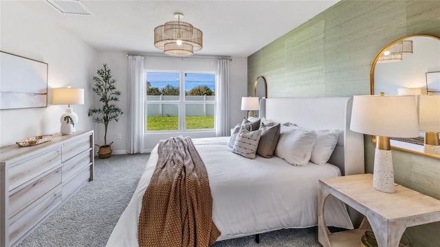 carpeted bedroom featuring visible vents and baseboards