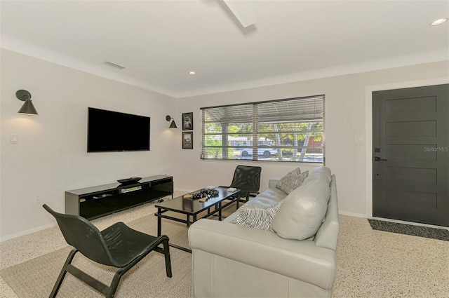 living area featuring speckled floor, recessed lighting, visible vents, and baseboards