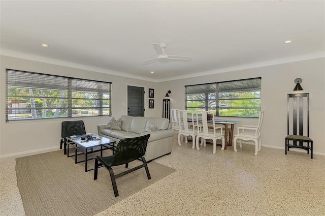 living area with recessed lighting, light speckled floor, a ceiling fan, and baseboards