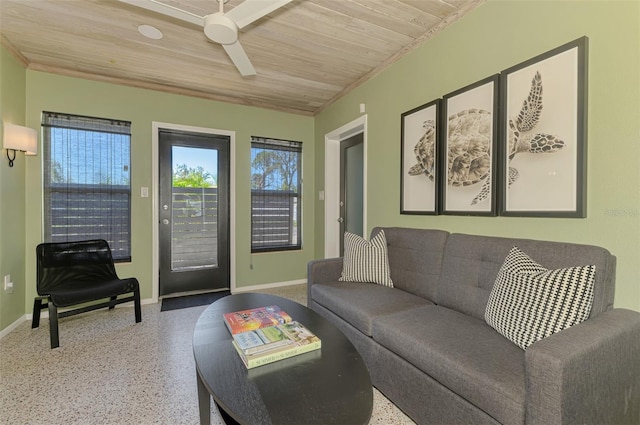 living area with a wealth of natural light, speckled floor, wooden ceiling, and a ceiling fan