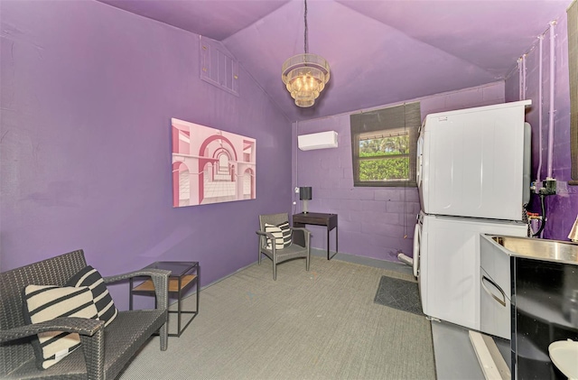 miscellaneous room featuring stacked washer / dryer, an AC wall unit, lofted ceiling, carpet floors, and an inviting chandelier