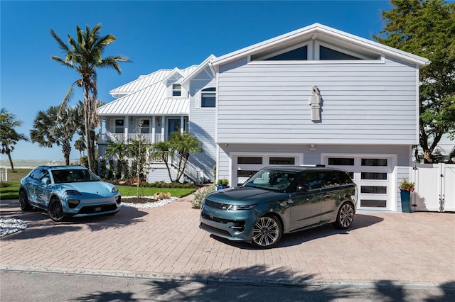 137 Big Pass Ln, Sarasota, FL 34242 - view of front facade with a gate, a garage, stairs, and decorative driveway