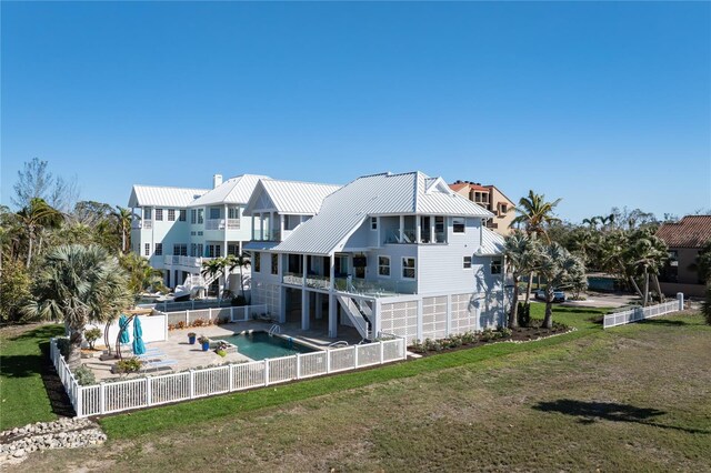 137 Big Pass Ln, Sarasota, FL 34242 - rear view of house with stairs, a fenced backyard, metal roof, a patio, and a yard