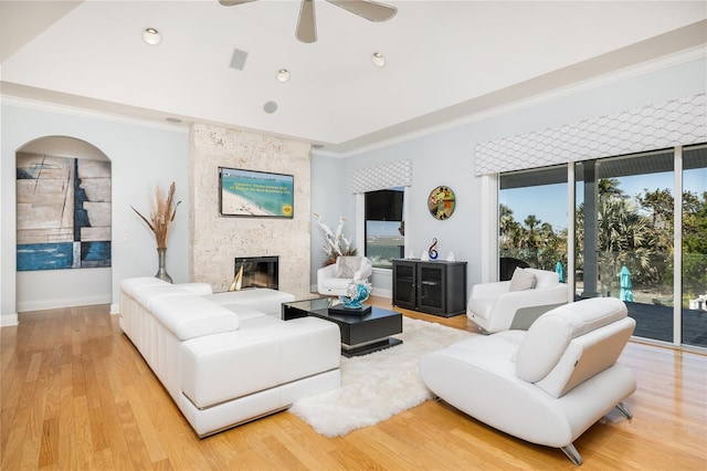 137 Big Pass Ln, Sarasota, FL 34242 - living room featuring crown molding, a large fireplace, light wood-type flooring, and a ceiling fan