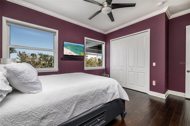 137 Big Pass Ln, Sarasota, FL 34242 - bedroom featuring ornamental molding, baseboards, dark wood-style floors, a ceiling fan, and a closet