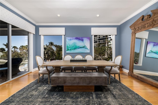 137 Big Pass Ln, Sarasota, FL 34242 - dining space with a wealth of natural light, wood finished floors, baseboards, and ornamental molding