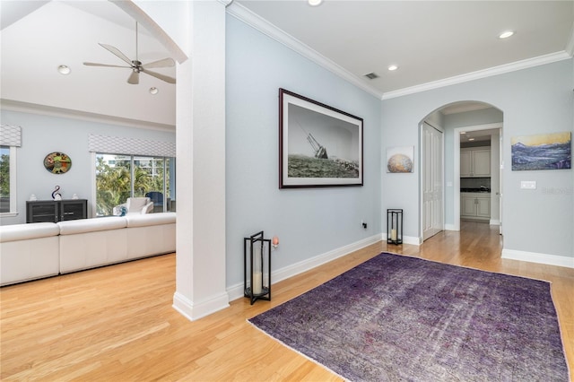 137 Big Pass Ln, Sarasota, FL 34242 - hall with crown molding, wood finished floors, baseboards, visible vents, and arched walkways