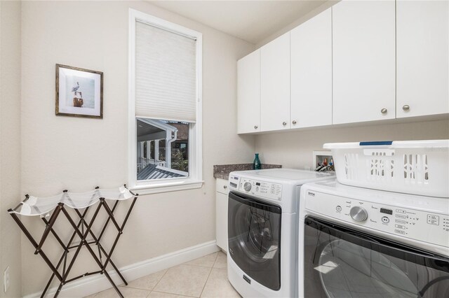 137 Big Pass Ln, Sarasota, FL 34242 - washroom featuring light tile patterned floors, cabinet space, baseboards, and separate washer and dryer