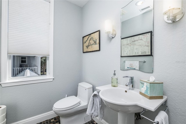 137 Big Pass Ln, Sarasota, FL 34242 - half bath with baseboards, visible vents, and toilet