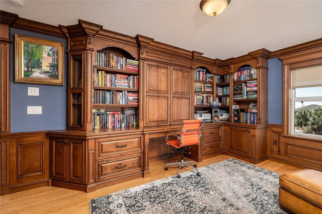 137 Big Pass Ln, Sarasota, FL 34242 - home office featuring light wood finished floors, wainscoting, and built in study area