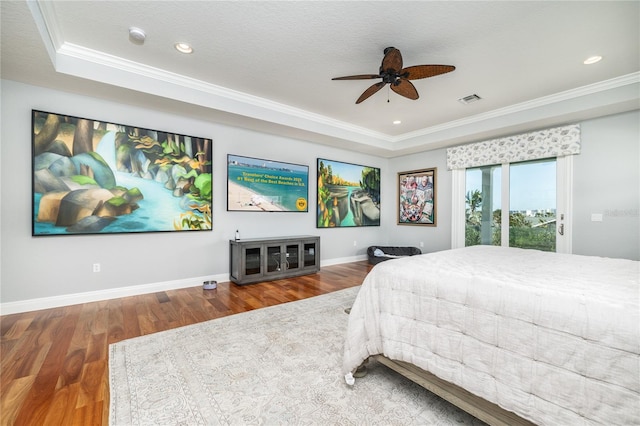 137 Big Pass Ln, Sarasota, FL 34242 - bedroom featuring a tray ceiling, ornamental molding, baseboards, access to outside, and wood finished floors