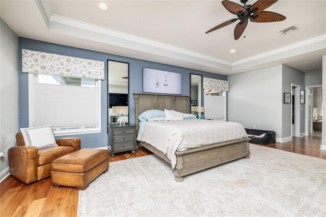 137 Big Pass Ln, Sarasota, FL 34242 - bedroom with a tray ceiling, visible vents, crown molding, and wood finished floors