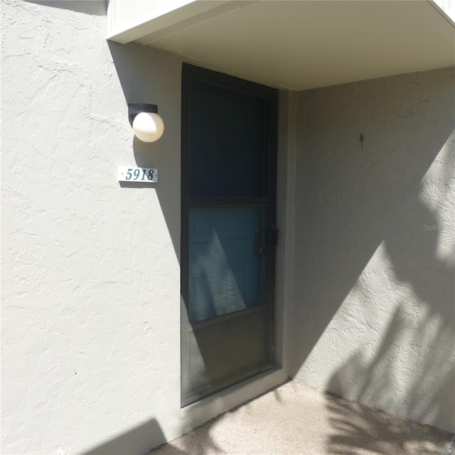 view of exterior entry with stucco siding