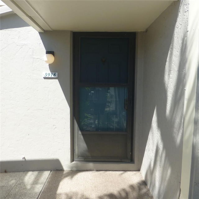 view of exterior entry with stucco siding